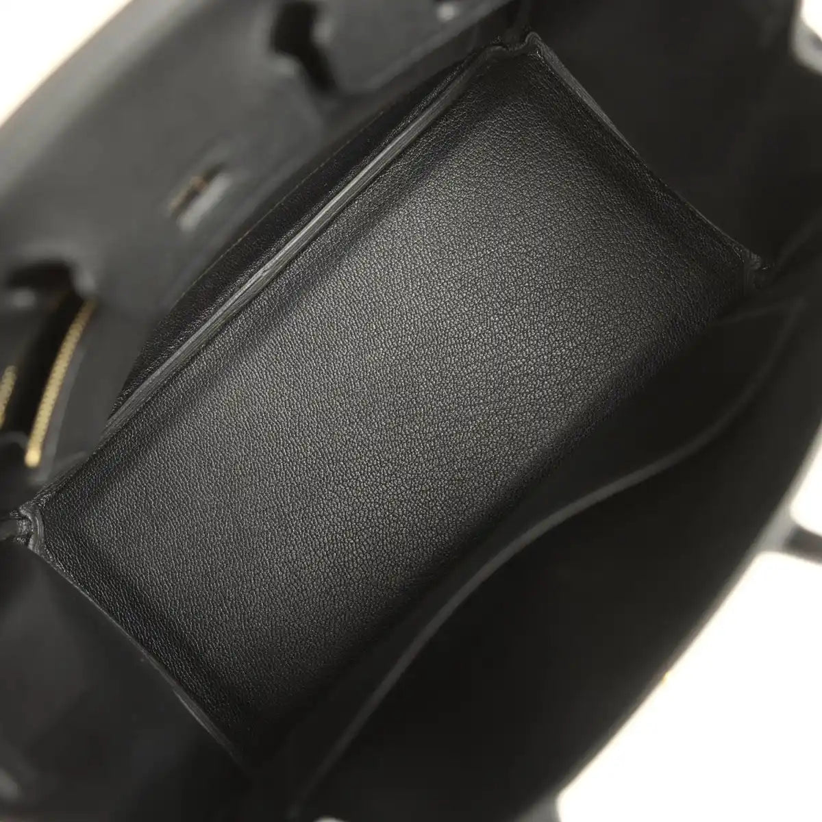 Black leather handbag interior pocket detail with textured lining