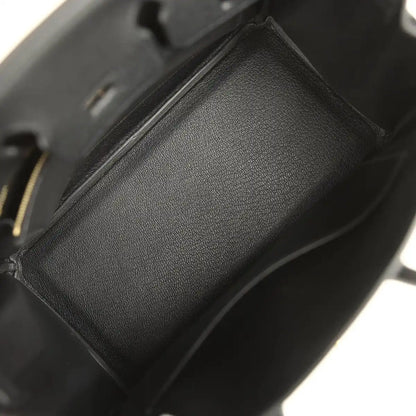 Black leather handbag interior pocket detail with textured lining