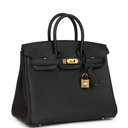 Black leather handbag with gold front clasp and padlock charm, top handles