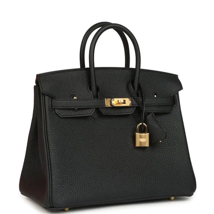 Black leather handbag with gold front clasp and padlock charm, top handles