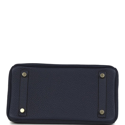 Hermes Birkin 25 handbag in dark blue leather with two exterior strap tabs and studs.