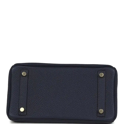 Hermes Birkin 25 handbag in dark blue leather with two exterior strap tabs and studs.