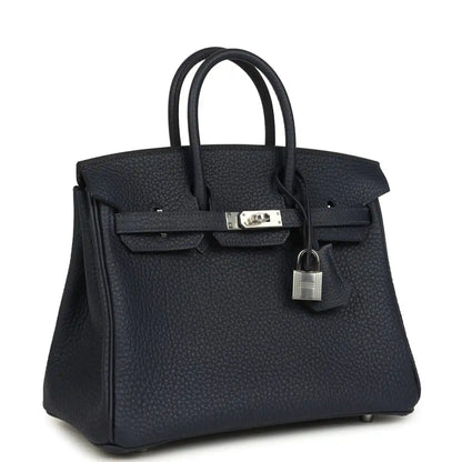 Birkin 25 handbag three-quarter view in dark blue pebbled leather with front lock