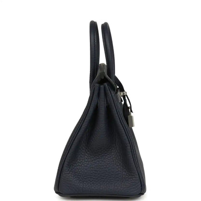 Birkin 25 handbag side view with dark blue pebbled leather and metal lock charm