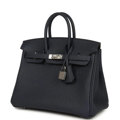 Birkin 25 handbag in dark blue pebbled leather with front flap lock and top handles