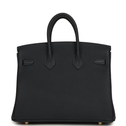 Black leather Birkin-style handbag back view with subtle seams and gold feet