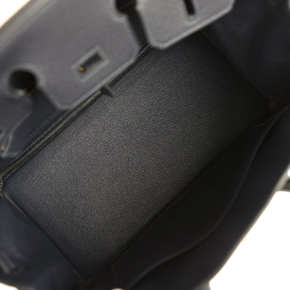Black leather Birkin-style handbag interior with dark lining and edge trim