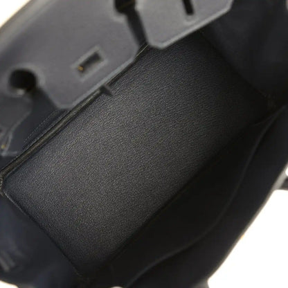 Black leather Birkin-style handbag interior with dark lining and edge trim