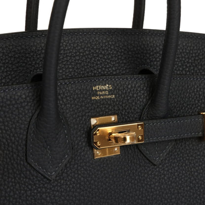 Black leather Birkin-style handbag with gold turn-lock and top handle tabs