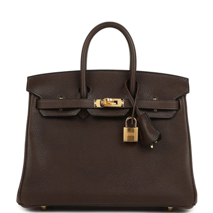 Brown leather handbag with top handles, front flap and hanging gold lock