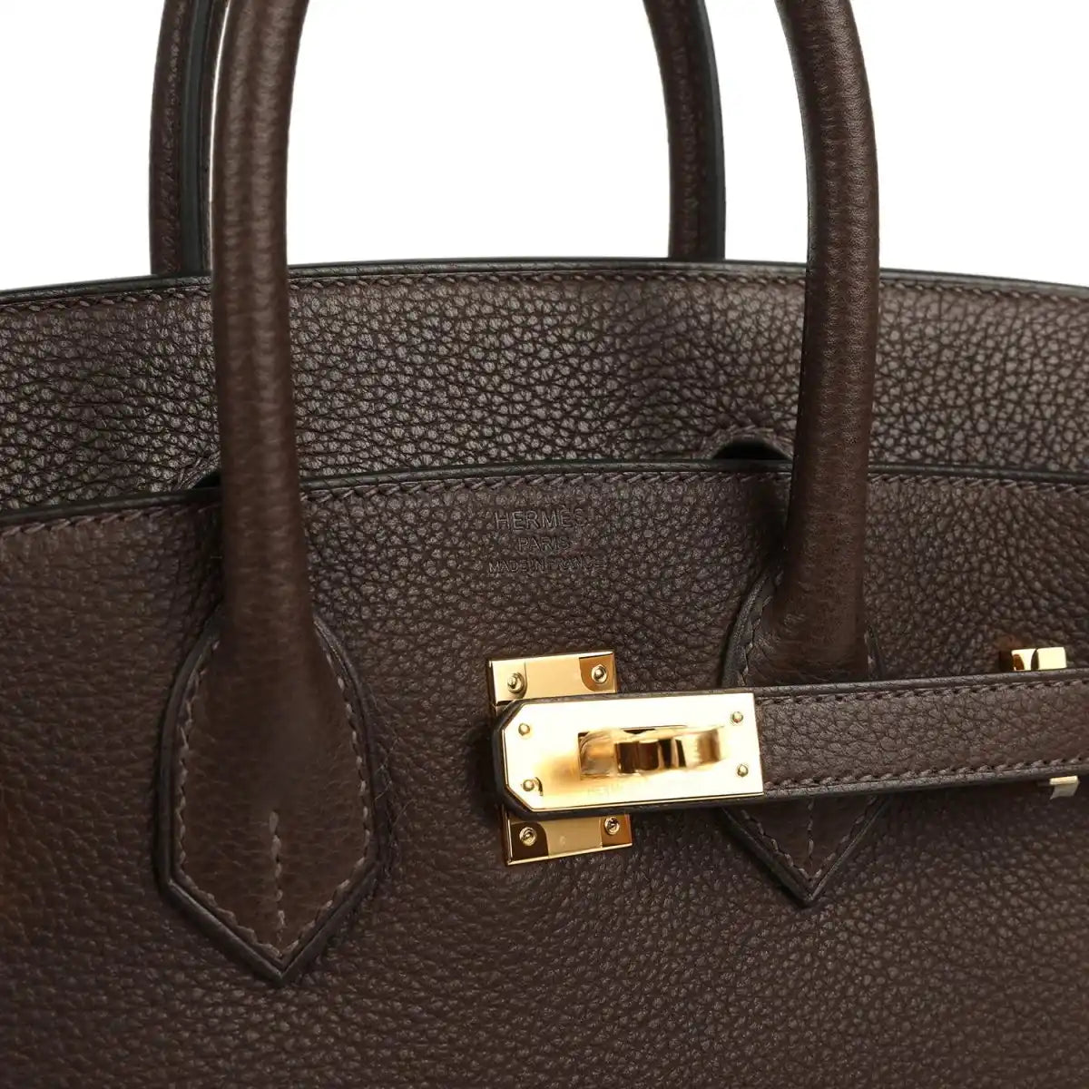 Brown leather handbag strap detail with gold-tone clasp and stitching