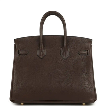 Brown leather tote with top handles, front flap and gold-tone details
