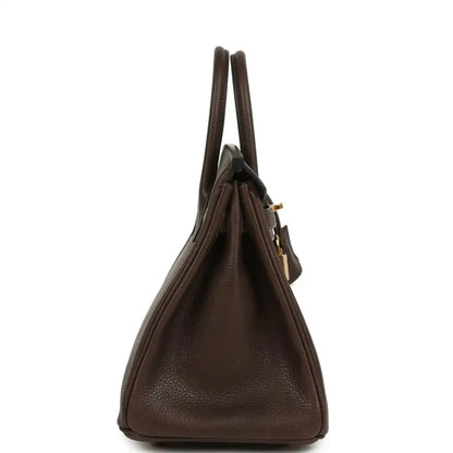 Brown leather handbag with two top handles, gold-tone hardware