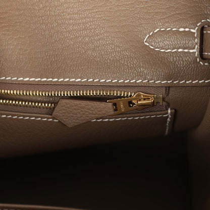 Hermès Birkin 25 handbag close-up of gold zipper and leather pull tab inside