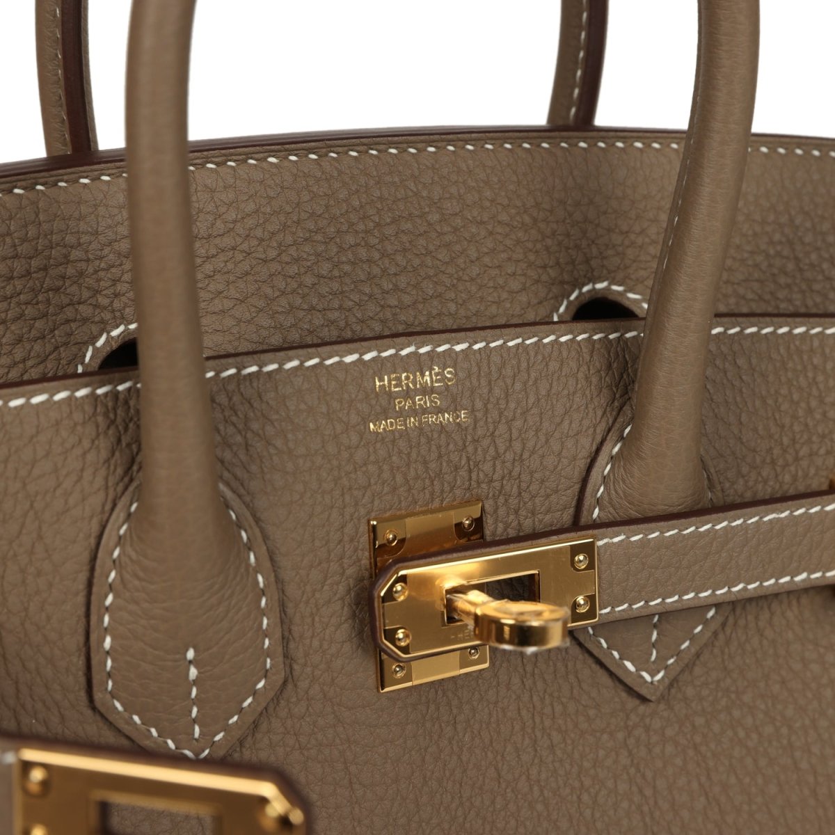 Hermès Birkin 25 handbag detail: gold clasp on etoupe leather with contrast stitching