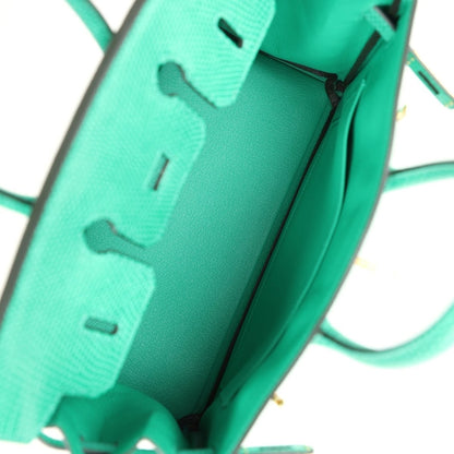 Mint green lizard handbag interior with partial stamp and side strap