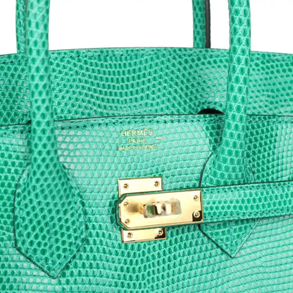Hermes Paris stamped lizard handbag flap with gold-tone lock hardware