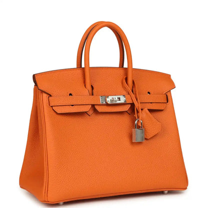 Orange leather Birkin 25 handbag front view with hinged lock and dangling padlock charm