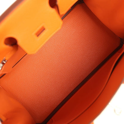 Orange leather Birkin 25 handbag interior pocket area with structured lining and corner edge