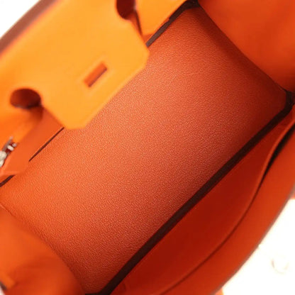Orange leather Birkin 25 handbag interior pocket area with structured lining and corner edge