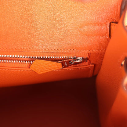Orange leather Birkin 25 handbag interior zipper pocket with small tag and pull tab