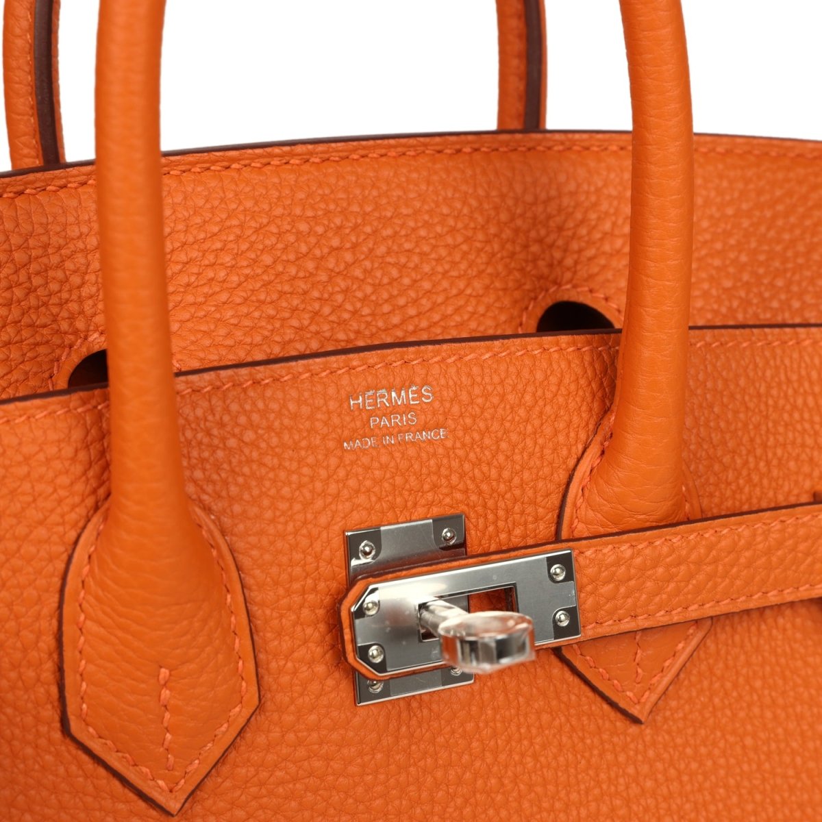 Orange leather Birkin 25 handbag interior view with stamped logo and front turn-lock hardware