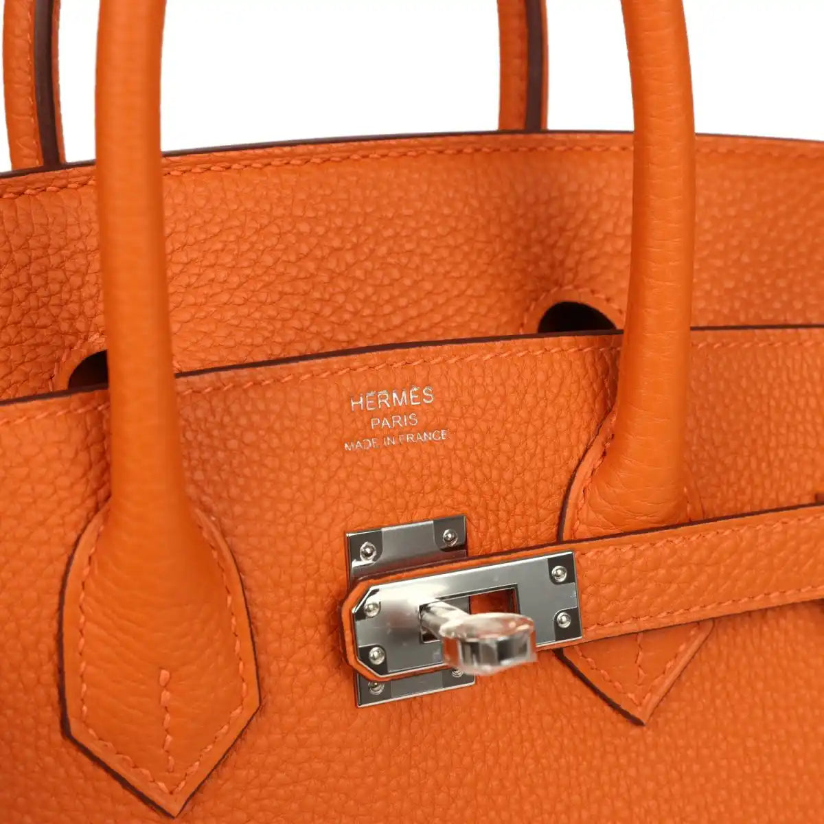 Orange leather Birkin 25 handbag interior view with stamped logo and front turn-lock hardware