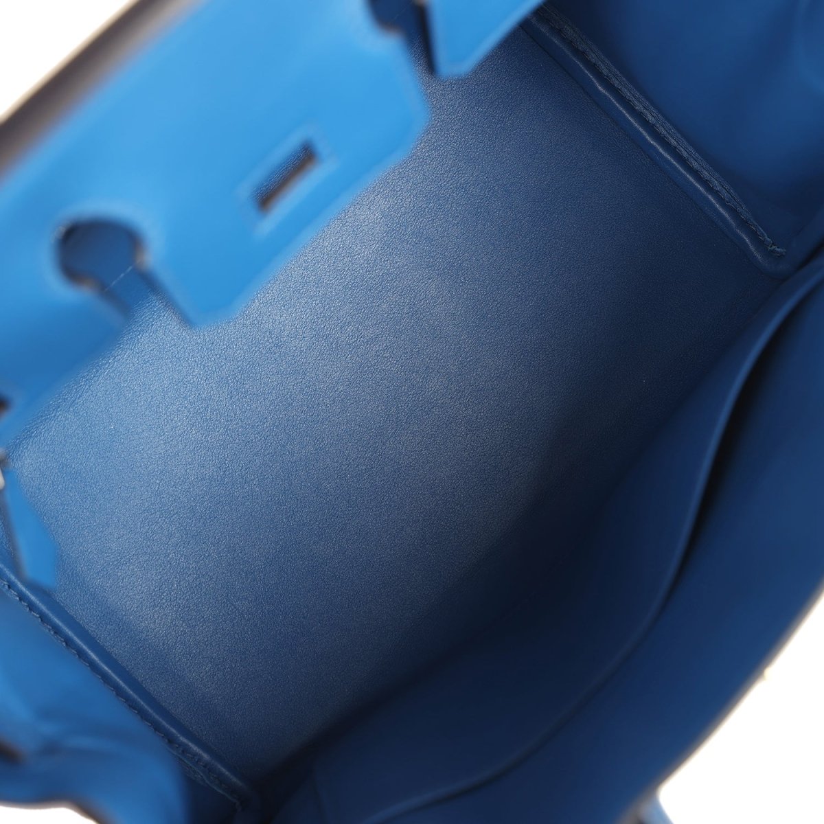 Blue leather interior panel with stitched details and strap opening