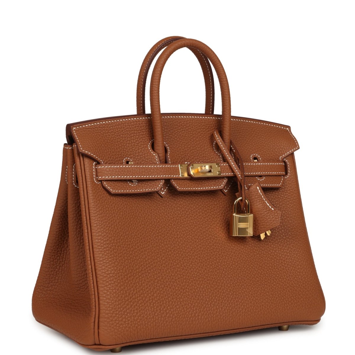 Tan leather handbag with gold-tone hardware, top handles, and front flap lock detail.