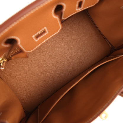 Tan leather handbag interior with stitched partition and top edge trim detail.
