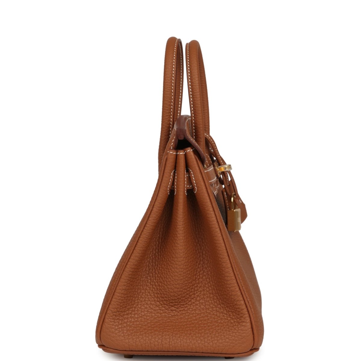Tan leather handbag viewed from the side, showing top handles and side strap hardware.