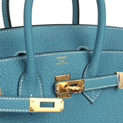 Teal-blue Togo leather handbag interior, showing logo stamp and gold-toned clasp hardware