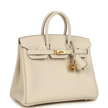 Birkin 25 top-handle handbag in light cream Togo leather with gold hardware, angled front