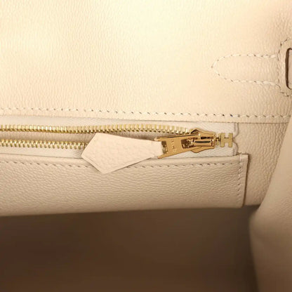 Birkin 25 handbag interior zipper track in light cream leather with gold zipper pull