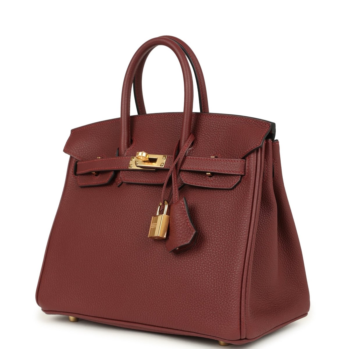 Burgundy leather top-handle handbag with gold lock, front flap and side panel.