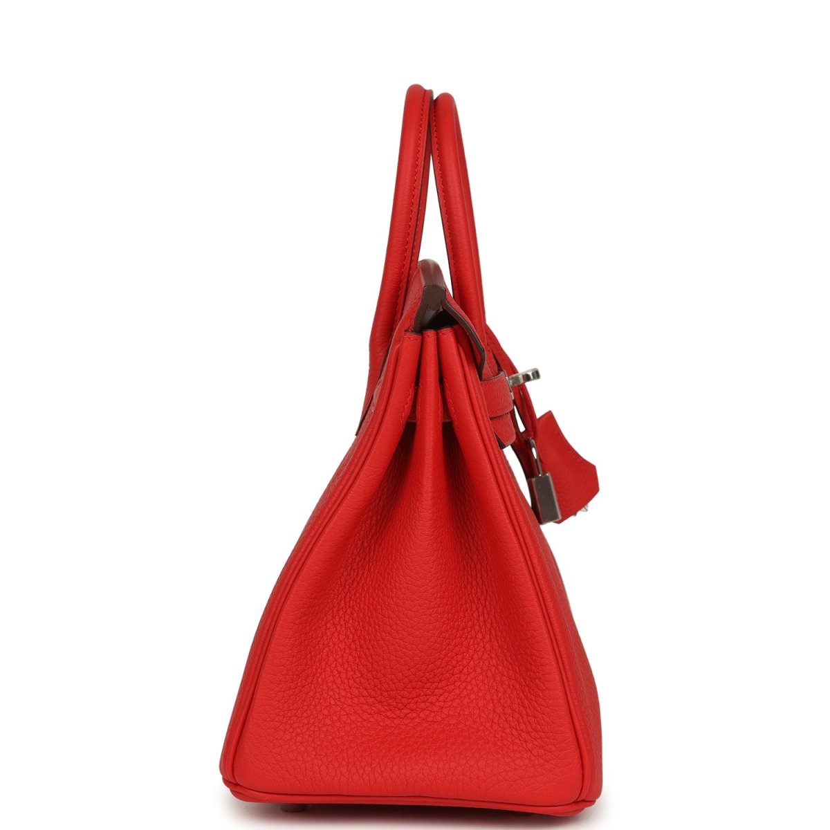 Red Hermes Birkin 25 handbag side view with top handles and hanging strap lock