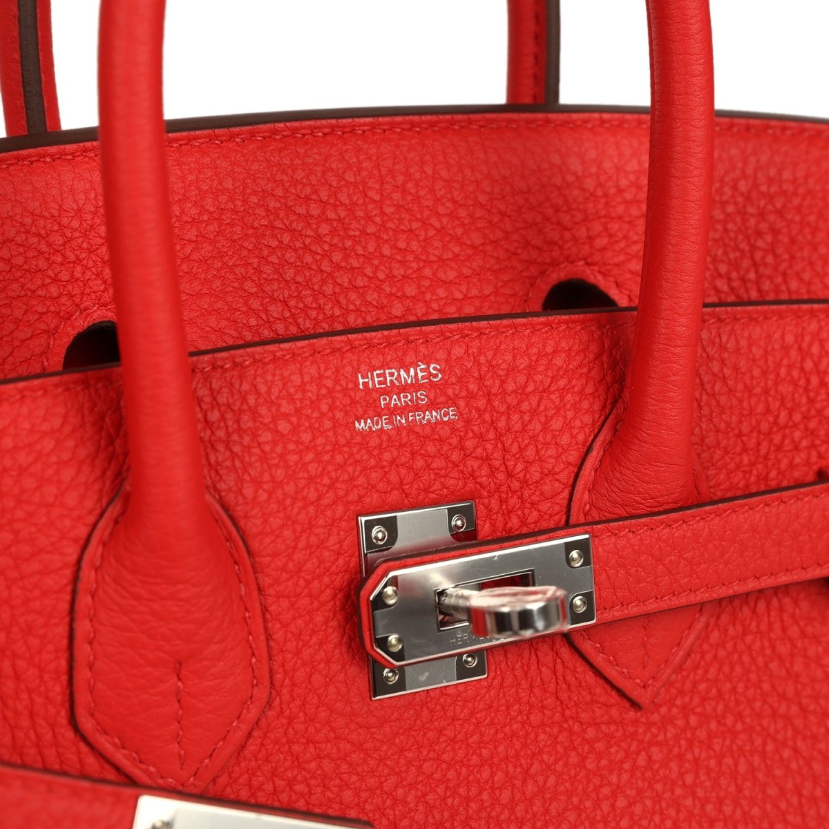 Red Hermes Birkin 25 handbag interior with Hermes stamp and metal clasp hardware