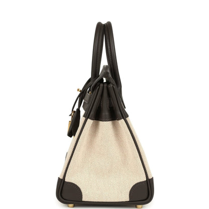 Small two-tone handbag with dark leather handles, beige canvas body and gold-tone lock charm