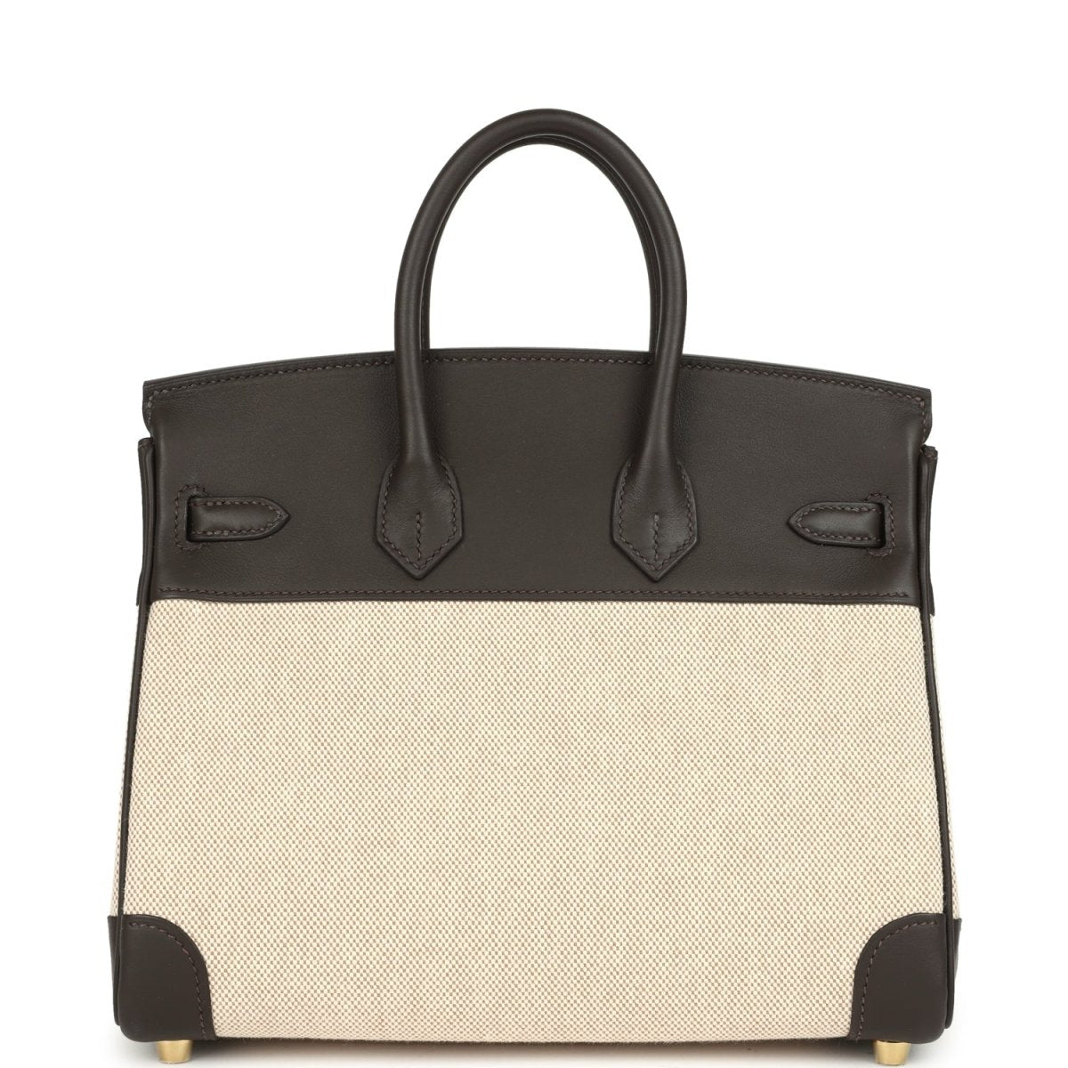 Two-tone handbag with dark leather handles, beige canvas body, gold-tone feet and trim