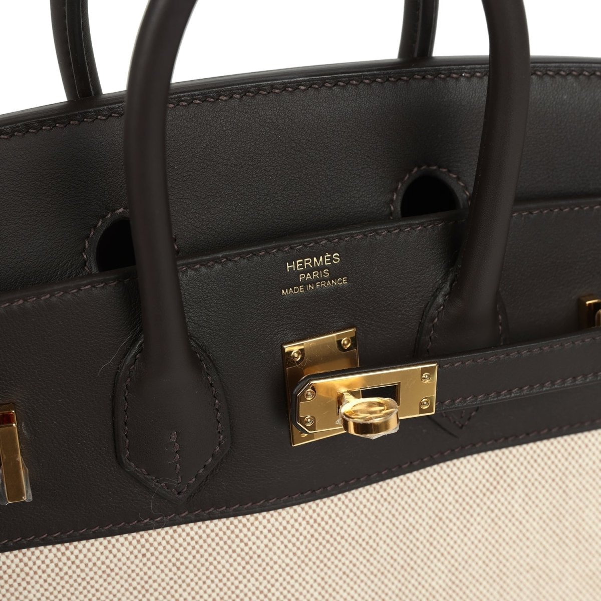 Hermes logo on dark leather flap with gold-tone turn-lock hardware and stitching