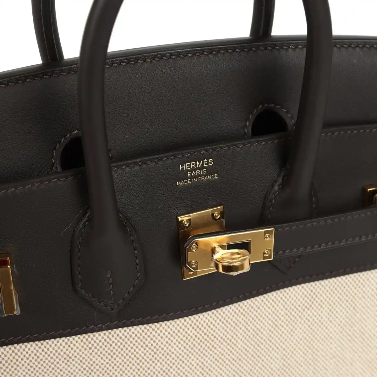 Hermes logo on dark leather flap with gold-tone turn-lock hardware and stitching