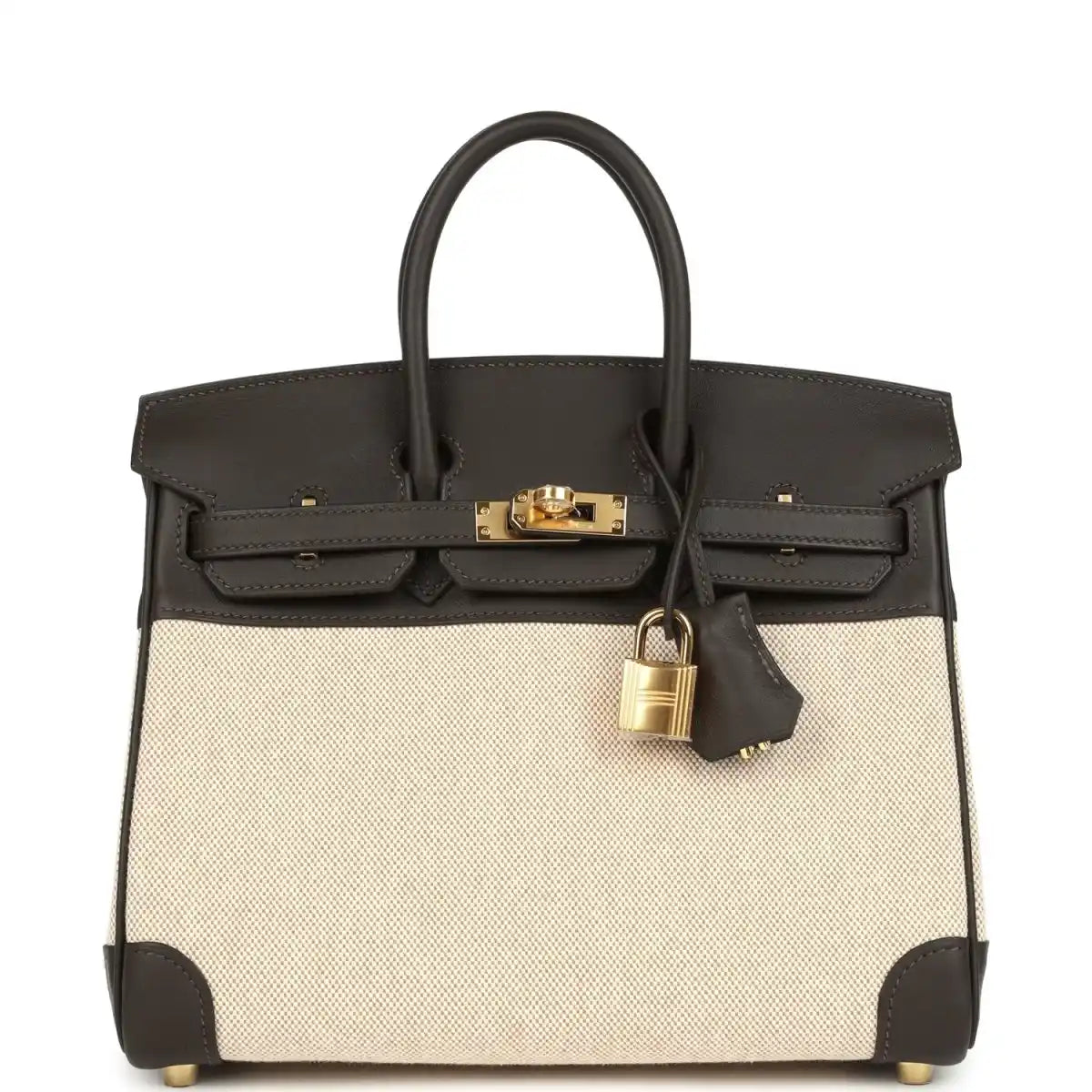 Two-tone handbag with dark leather top handles, beige canvas body, gold-tone lock and front flap