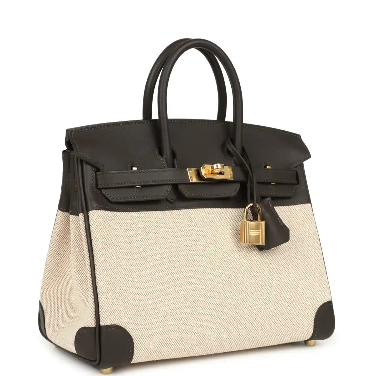 Two-tone handbag with dark leather trim, beige canvas body, gold-tone lock on top flap