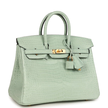 Light green croc-embossed handbag with front flap, gold turn-lock, and hanging key charm