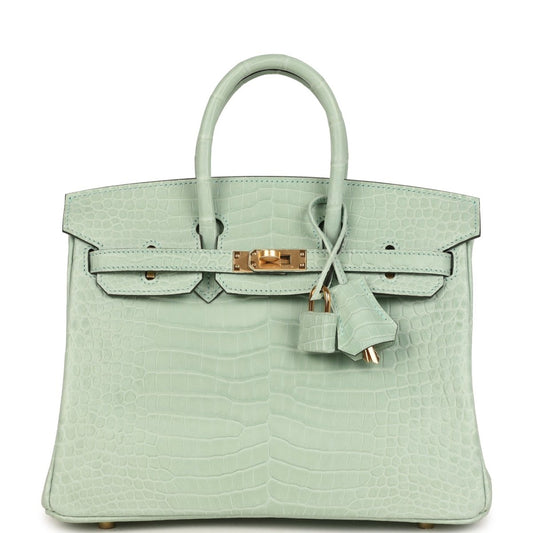 Light green croc-embossed handbag with twin top handles, front flap, and gold clasp