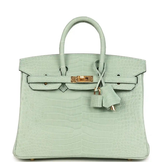 Light green croc-embossed handbag with twin top handles, front flap, and gold clasp