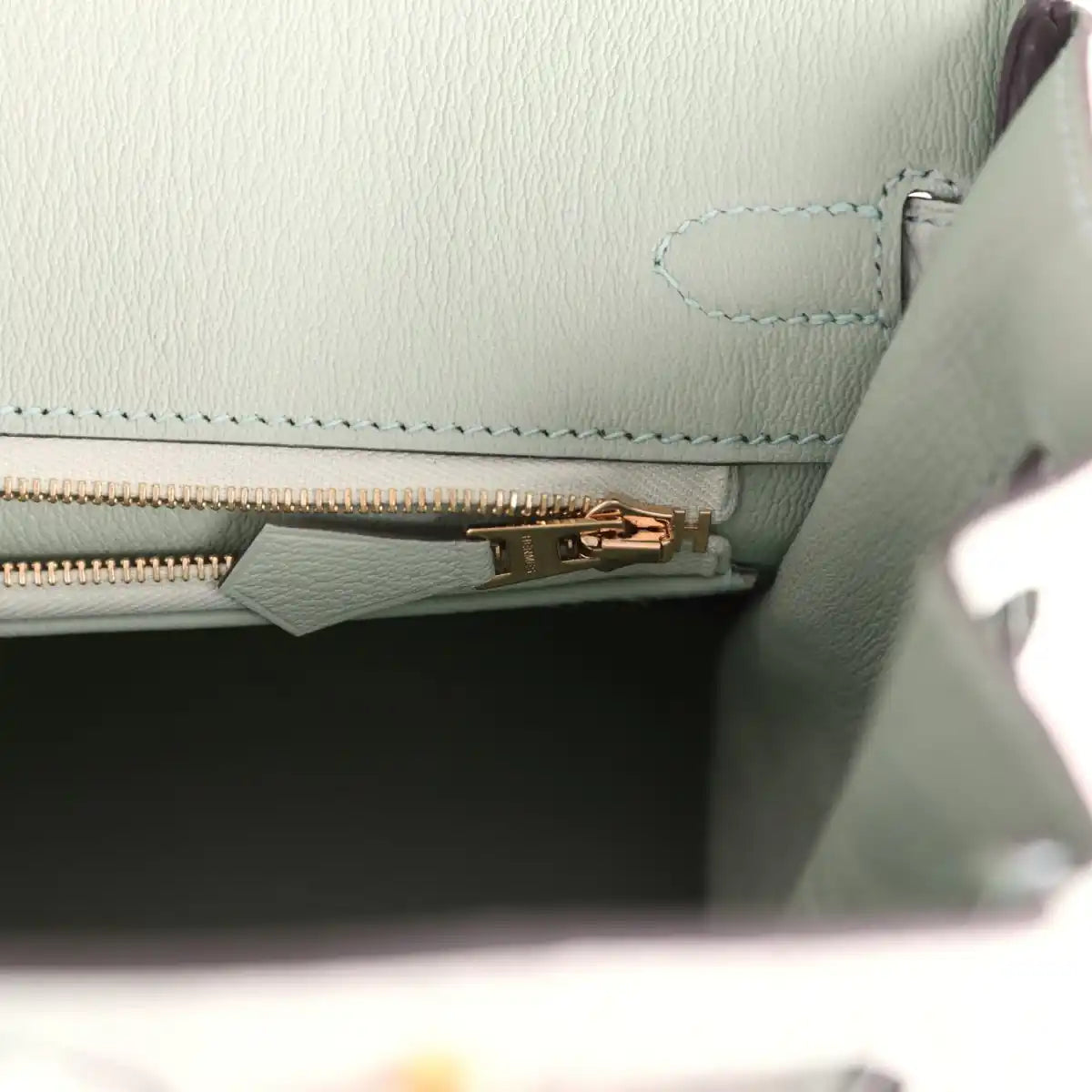 Light green croc-embossed handbag with gold zipper track and stitched trim