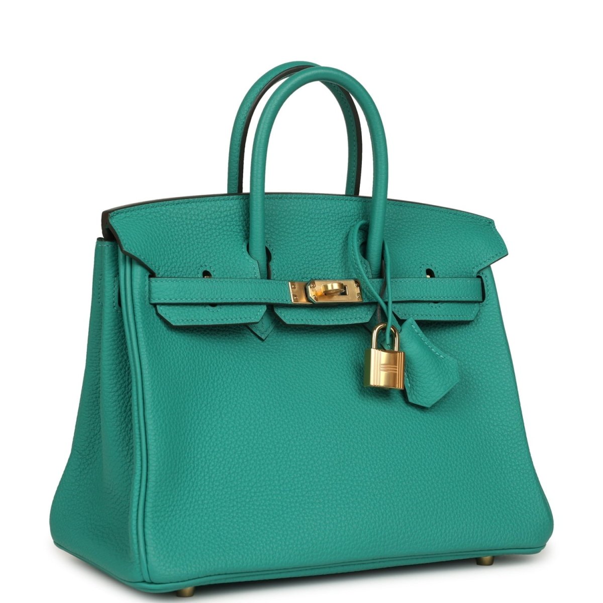 Green leather top-handle handbag with front strap, gold lock and hanging charm