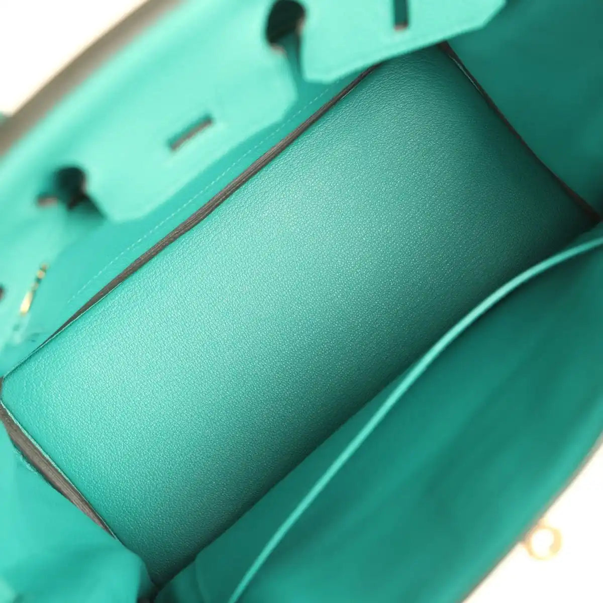 Green leather interior view with smooth lining and side seam stitching
