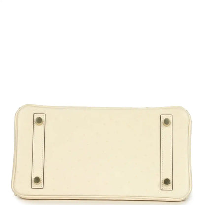 Nata leather handbag base with four corner snap studs and stitched edges.